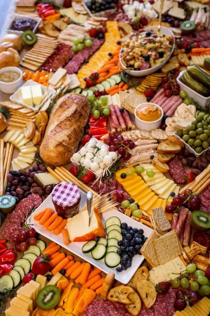 Close-up of a grazing table with cured meats, cheeses, fruit and crackers